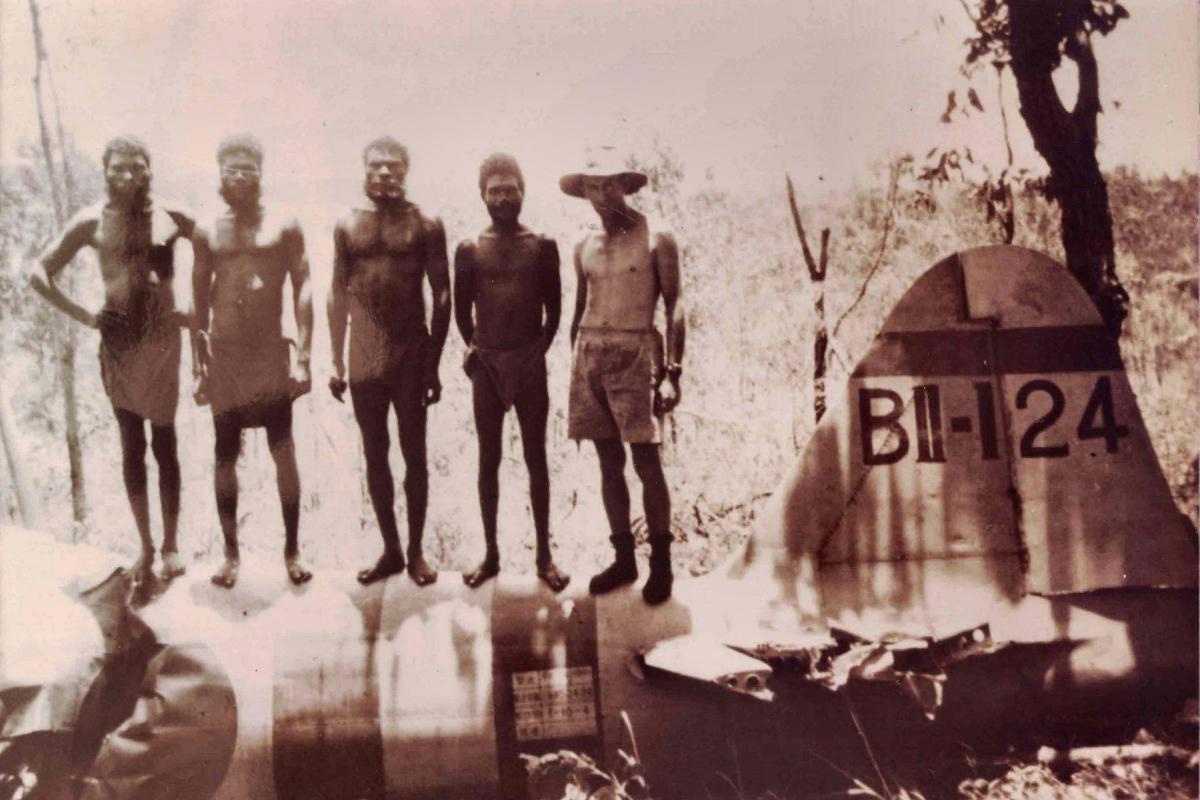 Tiwi men and RAAF personnel guard Hajime Toyoshima’s Mitsubishi A6M Zero.