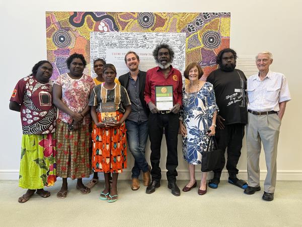 Wityana Marika and Matt Garrick pictured with family. (L-R) Shalyn Marika, Rakrakpuy Marika, Nayarri Yunupingu, Michelle Yunupingu, Matt Garrick, Witiyana Marika, Wendy James, Ratja Marika, and Earl James. 